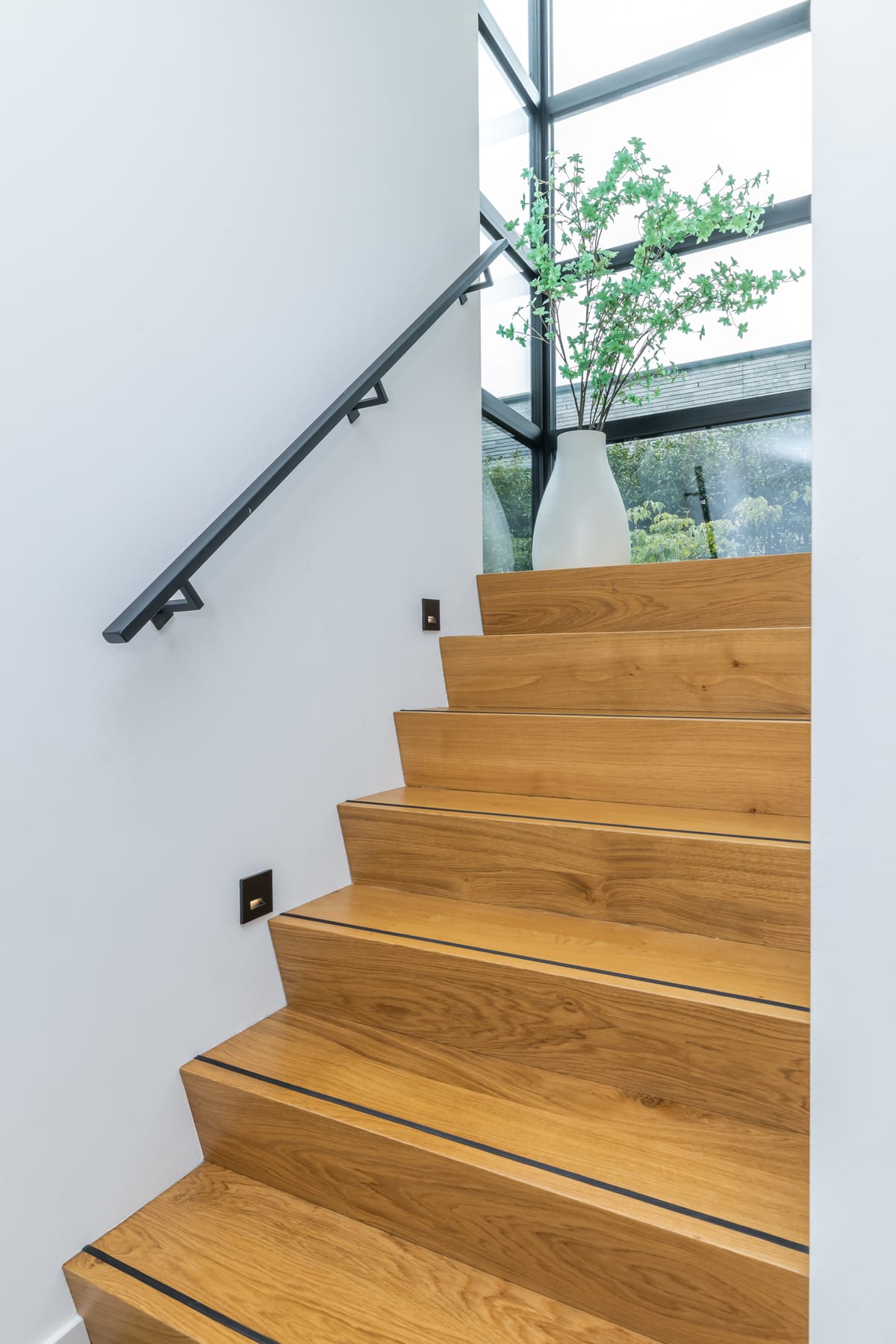 Oak staircase beside the glazing