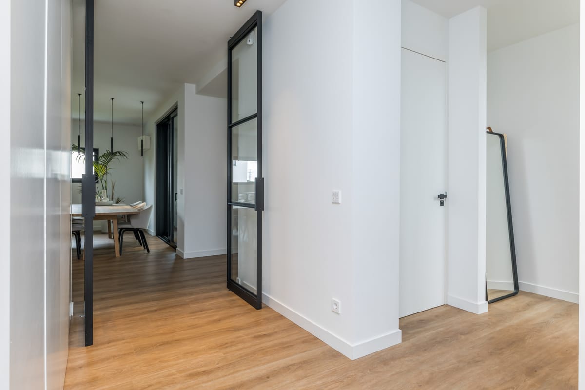Hall with steel-framed pivot doors